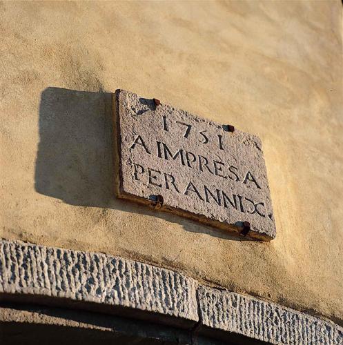 a stone sign on the side of a building at Azienda Agricola Fabbrica Di San Martino in Lucca