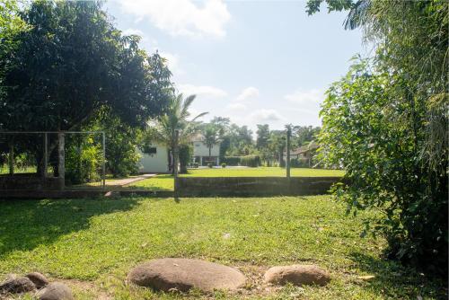 a park with rocks in the grass at Recanto do sossego!! in Morretes