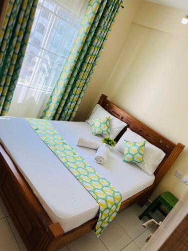 a small bedroom with a bed with a window at Uniplex Homes 1 bedroom in Mombasa