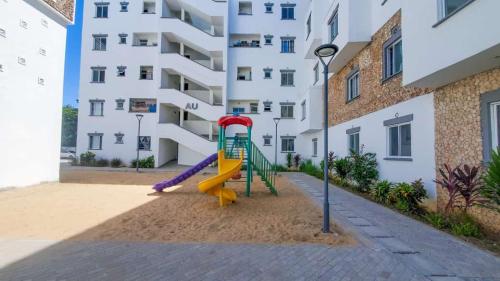a playground in front of a apartment building at Uniplex Homes 1 bedroom in Mombasa