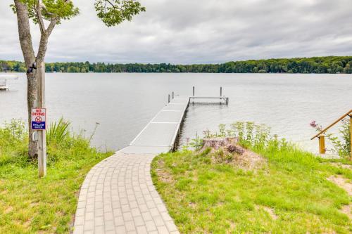 a dock on a lake with a sign on it at Lakefront Rhinelander Cottage with Private Dock! in Rhinelander