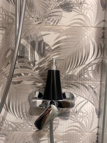 a bathroom with a shower head on a wall at Boheme Studio in Timişoara