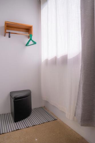 a chair sitting on a rug next to a window at Arenal Getaway in Fortuna