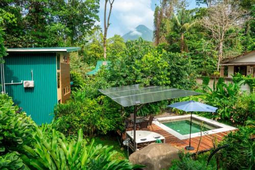 an aerial view of a garden with a pool and a house at Arenal Getaway in Fortuna