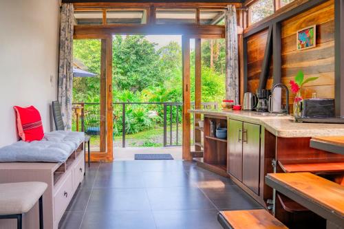 a kitchen with a large open door to a patio at Arenal Getaway in Fortuna