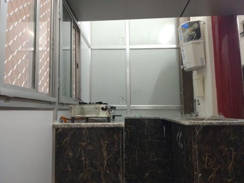 a bathroom counter with a mirror and a sink at Accommodation In Prayagraj Near Railway Station Triveni Sangam in Prayagraj