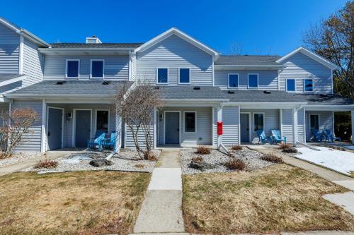 a large white house with blue shutters at Hilltop View in Fish Creek Unit B-3 by Simple Life Rentals in Fish Creek