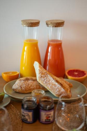 a table with a plate of food with jam and bread at Appartement bord de mer « La Petite Ma-Line » in Cagnes-sur-Mer