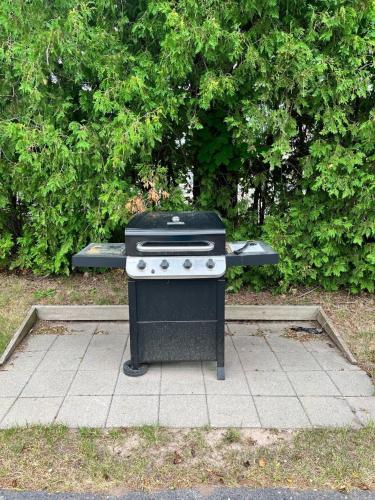 a black stove sitting on a sidewalk in a park at Hilltop Hideaway Unit B-5 by Simple Life Rentals in Fish Creek