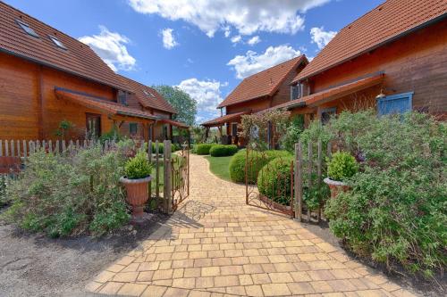 a brick walkway between two houses with a fence at Ferienhäuser Aura in St. Andrä am Zicksee