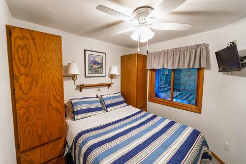 a bedroom with a bed and a ceiling fan at Cedar Haven Unit 202 by Simple Life Rentals in Ephraim