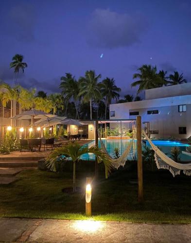a resort with a swimming pool at night at VILLAS M PATACHO - Aluga Apto F001 in Pôrto de Pedras