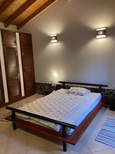 a bedroom with a bed in a room at Oleiro de Cima in São Teotónio