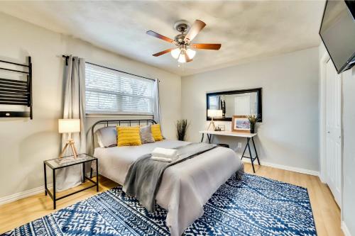 a bedroom with a bed and a ceiling fan at Global Cup Insta-Worthy Flat and Arboretum Tickets Included in Dallas