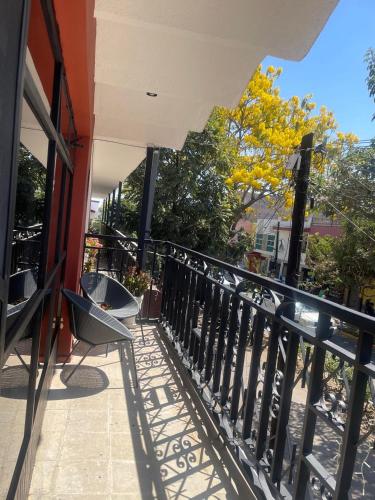 a balcony with a fence and a chair on it at Casa Hotel Marchel in Tequila