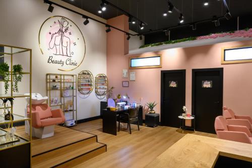 a beauty clinic with pink chairs and a table at Oaks Hotel  in Golan Heights