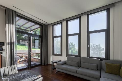 a living room with large windows and a couch at Divine Forest in Litochoro