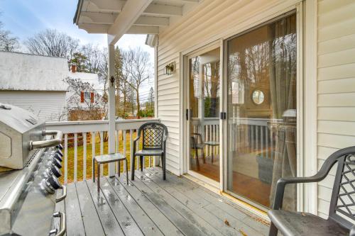 a porch with two chairs and a sliding glass door at Ski, Hike and Fish Dog-Friendly Gem in Conway in North Conway