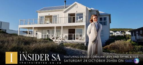 a woman standing in front of a house at Thyme & Tide Beach Villa in Yzerfontein