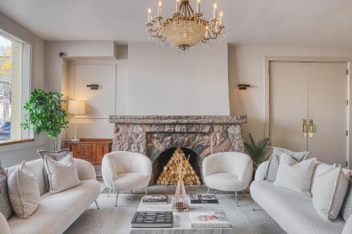 a living room with a fireplace and a chandelier at The Windsor Hotel by Hoco Hotels Collection in Stratford