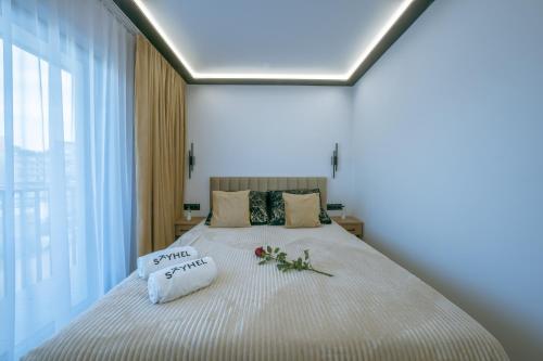 a bedroom with a large bed with flowers on it at SkyHel Apartament 103 in Hel