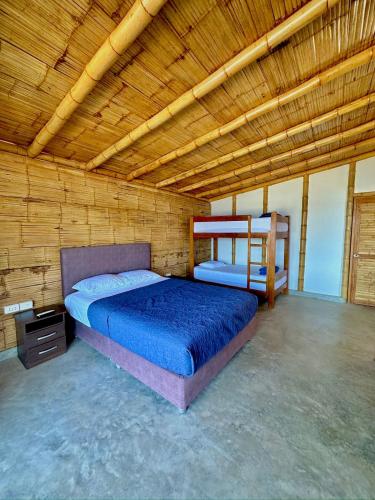 a bedroom with a bed and a wooden ceiling at Casa Kahuna in Canoas de Punta Sal