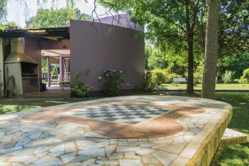 a stone patio with a chessboard on it in front of a house at Quinta La Gloria in La Plata