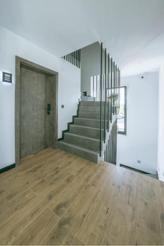 an empty room with stairs and a door at SkyHel Apartament 103 in Hel