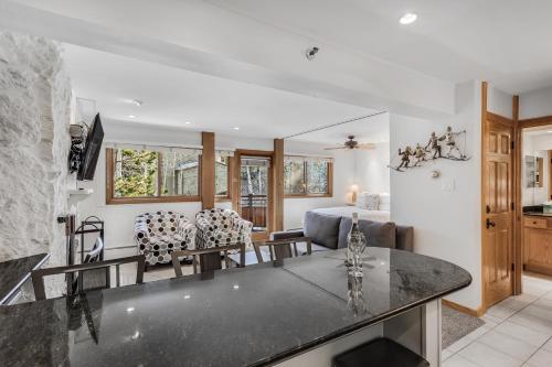 a kitchen and living room with a table and chairs at Laurelwood Condominiums 306 in Snowmass Village