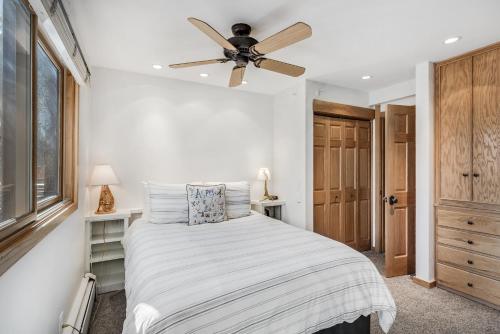 a bedroom with a bed with a ceiling fan at Laurelwood Condominiums 306 in Snowmass Village