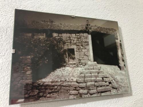 an old picture of a stone building on a wall at Covo Residence - Casa Santiago in Vila Nova de Paiva