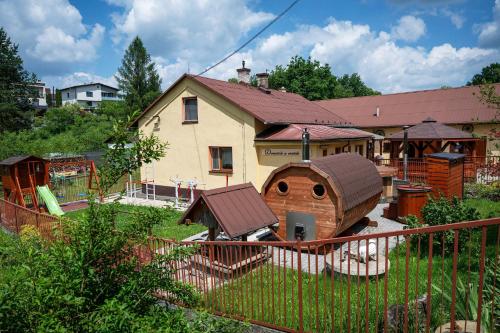 a house with a dog house in the yard at Agroturistika - "Domeček u oveček" in Horní Těrlicko