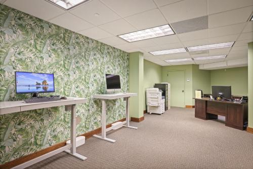 an office with green walls with a computer on a desk at Waipouli Beach Resort and Spa Kauai by OUTRIGGER in Kapaa