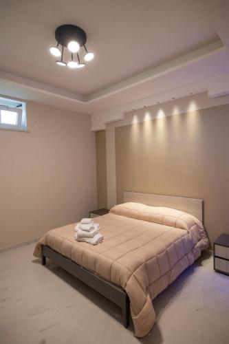 a bedroom with a bed with towels on it at Luxury Rooms in Somma Vesuviana