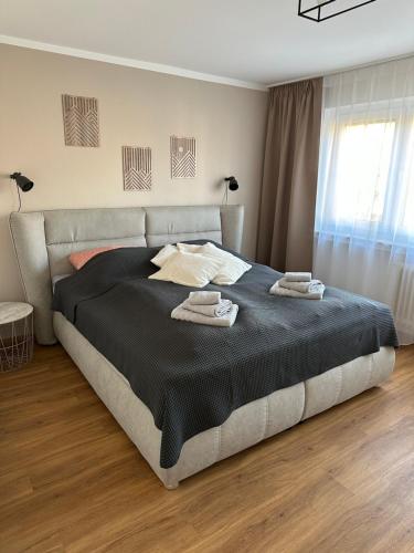 a bedroom with a large bed with two towels on it at Familienfreundliche FEWO in bester Lage in Offenburg