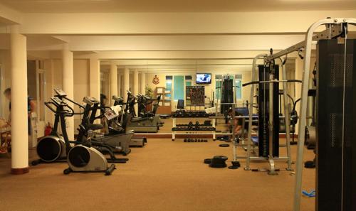 a gym with a lot of treadmills and machines at Grand Hotel Vung Tau in Vung Tau