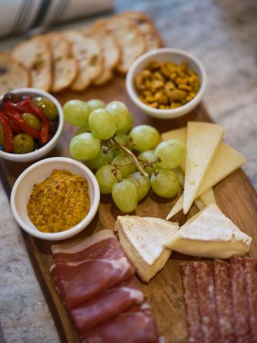 a plate of food with grapes cheese and other foods at Hotel Julian in San Francisco