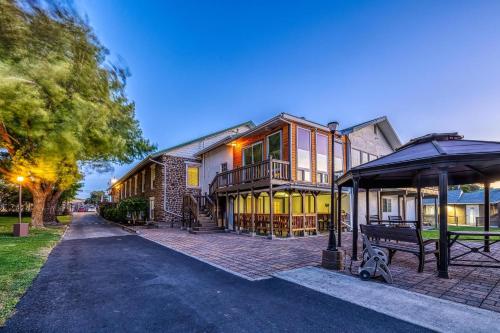 a large house with a bench in front of it at Soap Lake Natural Spa & Resort in Soap Lake