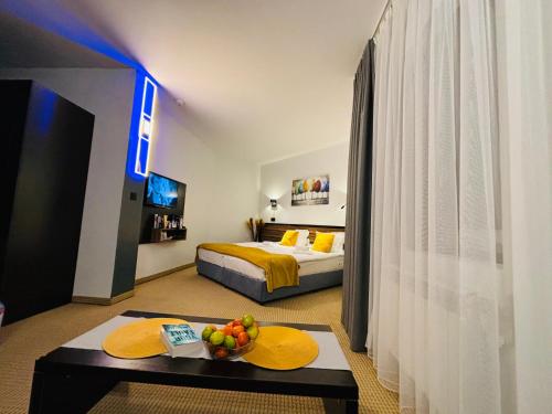 a bedroom with a bed and a table with a bowl of fruit at Passion & Sense Studios Pamporovo in Pamporovo