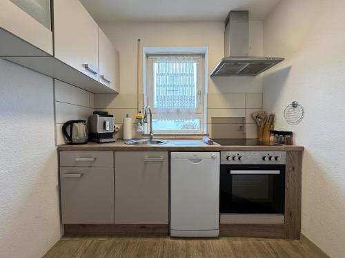 a small kitchen with a sink and a stove at Riva in Überlingen