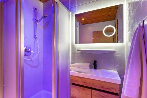 a purple bathroom with a sink and a shower at Mountainresort Seiwald in Prama