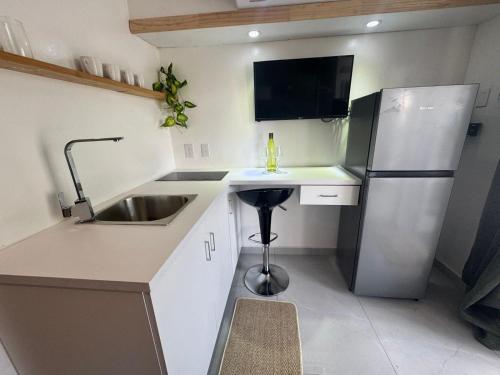 a small kitchen with a sink and a refrigerator at 4BlessingsCuracao2 in Willemstad