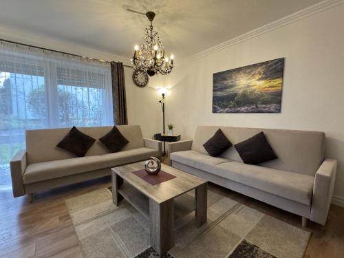 a living room with two couches and a table at Riva in Überlingen