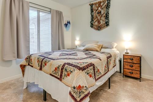 a bedroom with a bed and a dresser and a window at 11 Mi to Sand Hollow State Park Home with Fire Pits in Hurricane