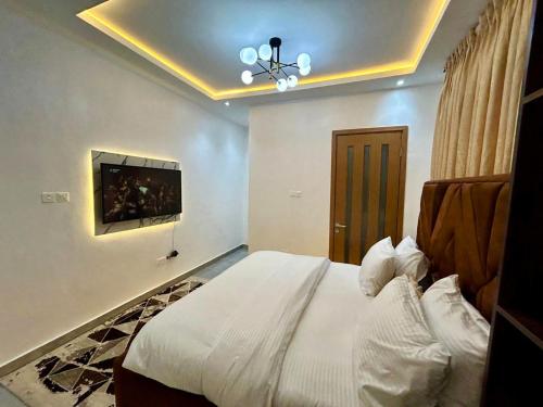 a bedroom with a bed and a tv on the ceiling at Providence LUXE 3 Bed Apartment in Lekki