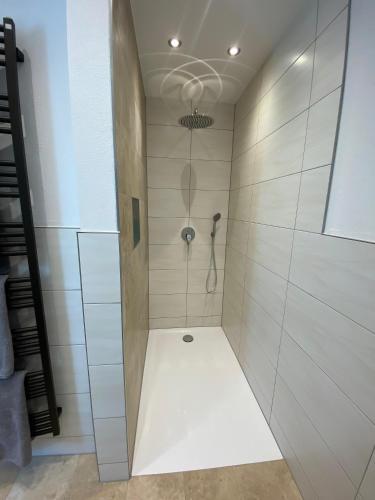 a bathroom with a shower with a glass door at Ferienwohnung Plechau in Russbach am Pass Gschütt