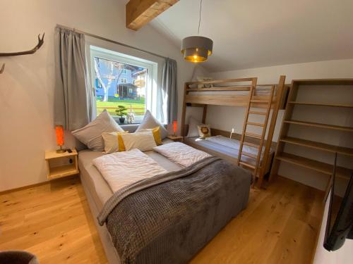 a bedroom with a bunk bed and a ladder at Ferienwohnung Plechau in Russbach am Pass Gschütt