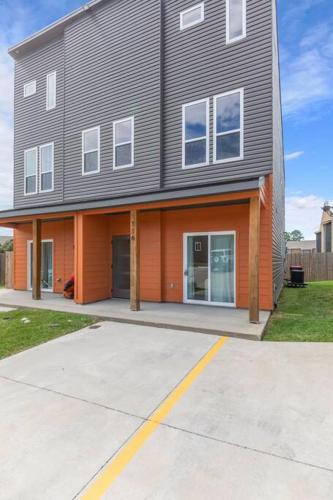 a large house with an orange and gray at Teche House KING Bed Luxury Getaway Fast WiFi in Lafayette