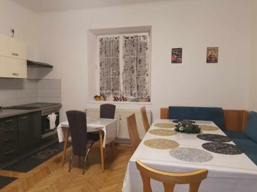 a kitchen with a table and chairs and a kitchen with a window at Eisenerzer Apartments - Radmeisterhaus in Eisenerz