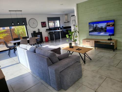 a living room with a couch and a table at Gîte 1 Newlook in Trélissac